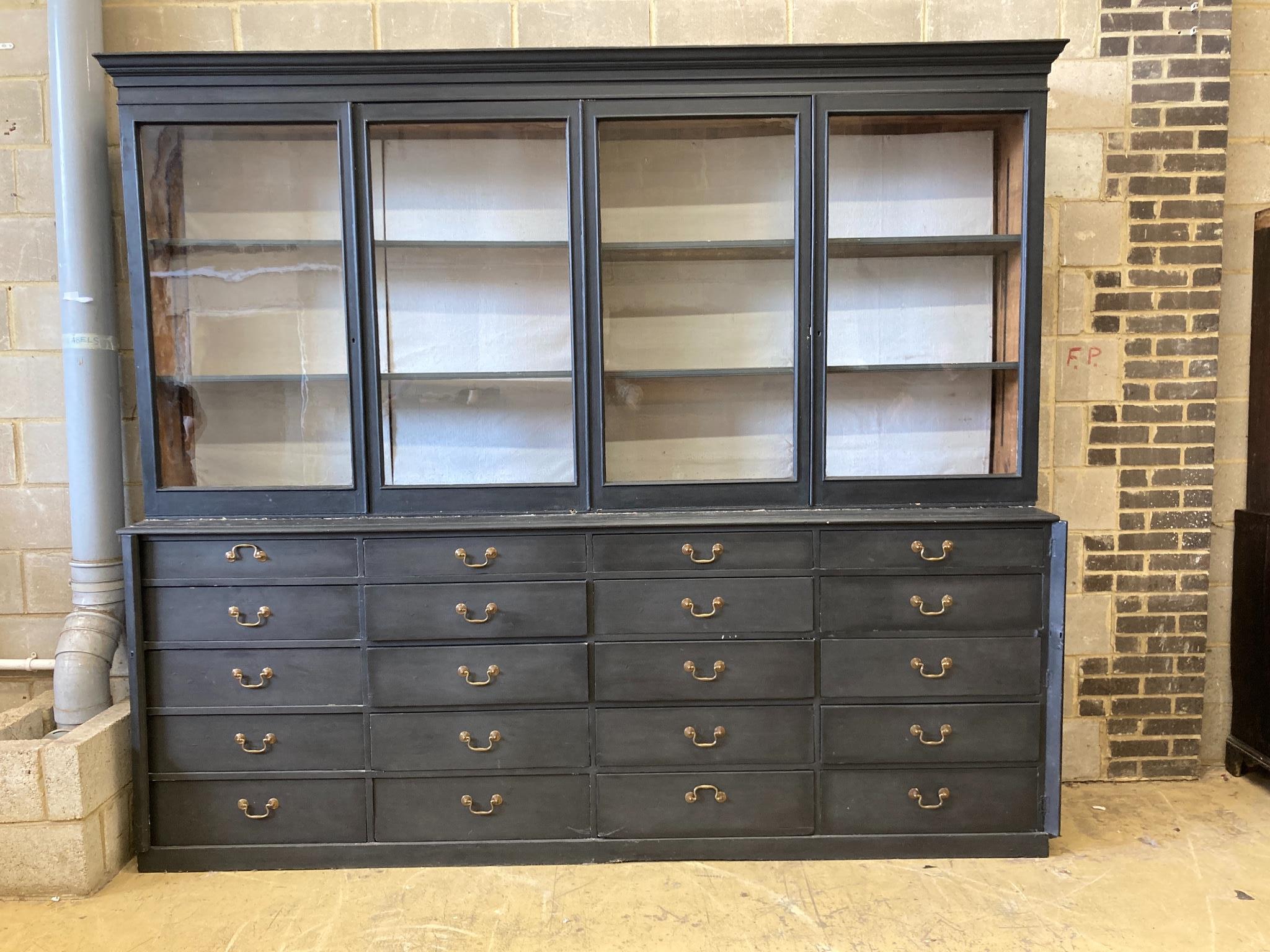 A Victorian painted pine glazed cabinet fitted twenty drawers, by repute The Bible Cabinet from Westminster Abbey, length 280cm, depth 54cm, height 244cm